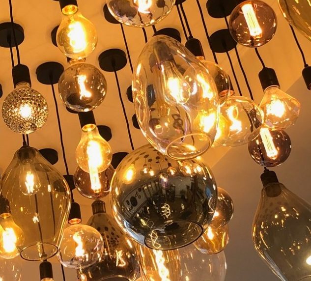 Cluster of lights in all multiple shapes and sizes handing from ceiling