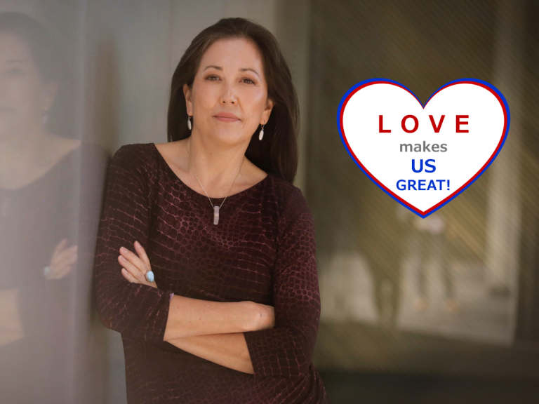 Joyce leaning against a reflective wall.